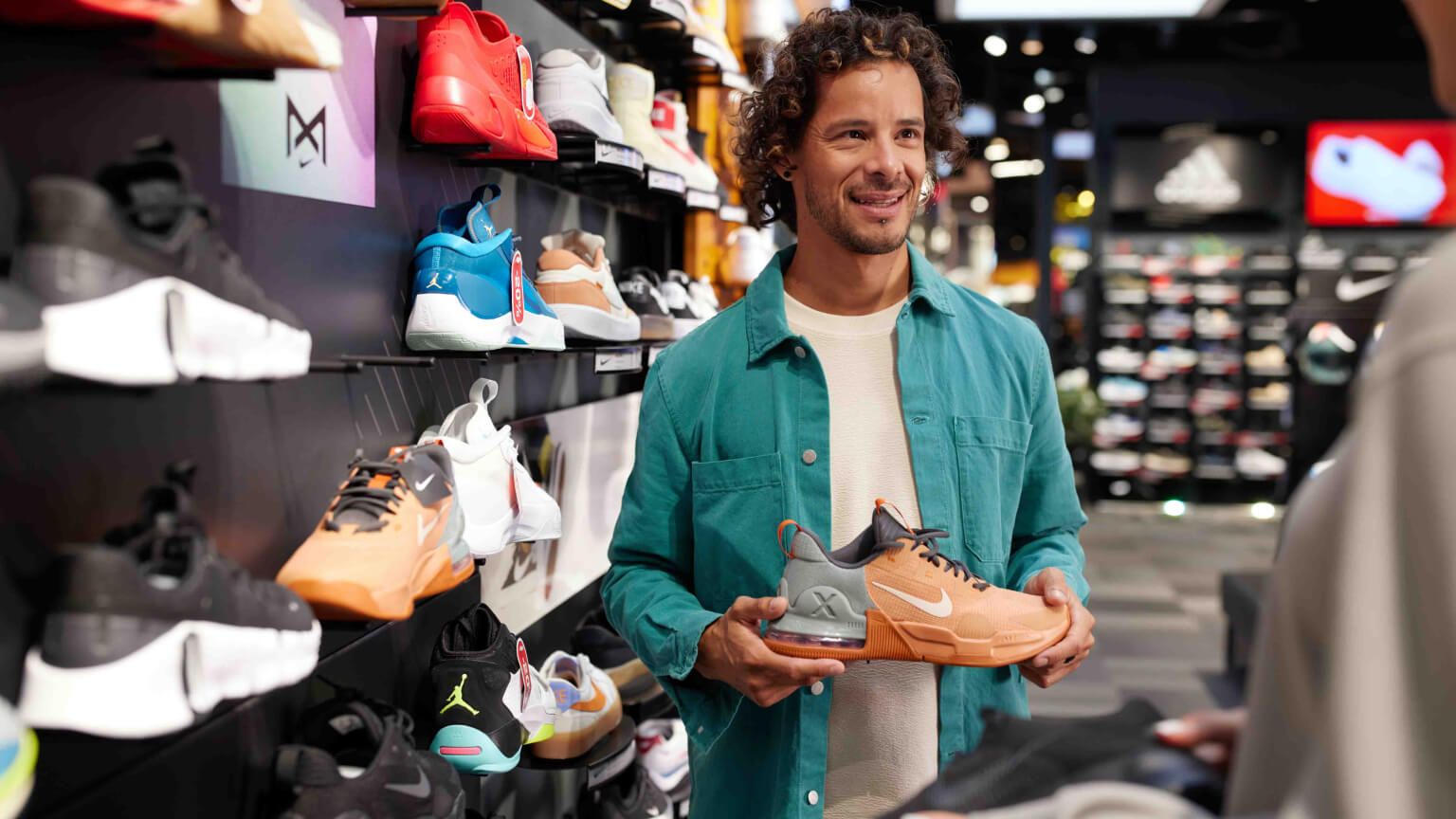 man-in-store-holding-shoe